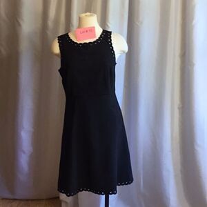 Little black dress with eyelet decorations throughout in size small